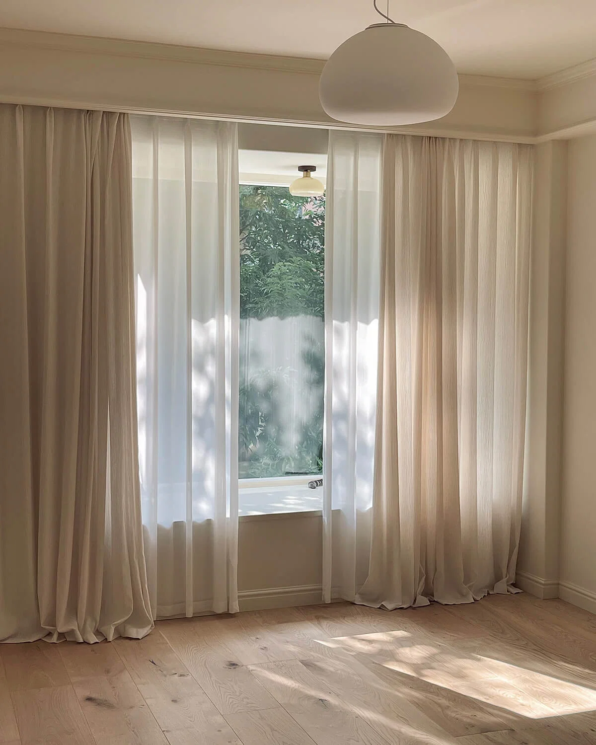Light filtering sheers in a bright townhouse interior
